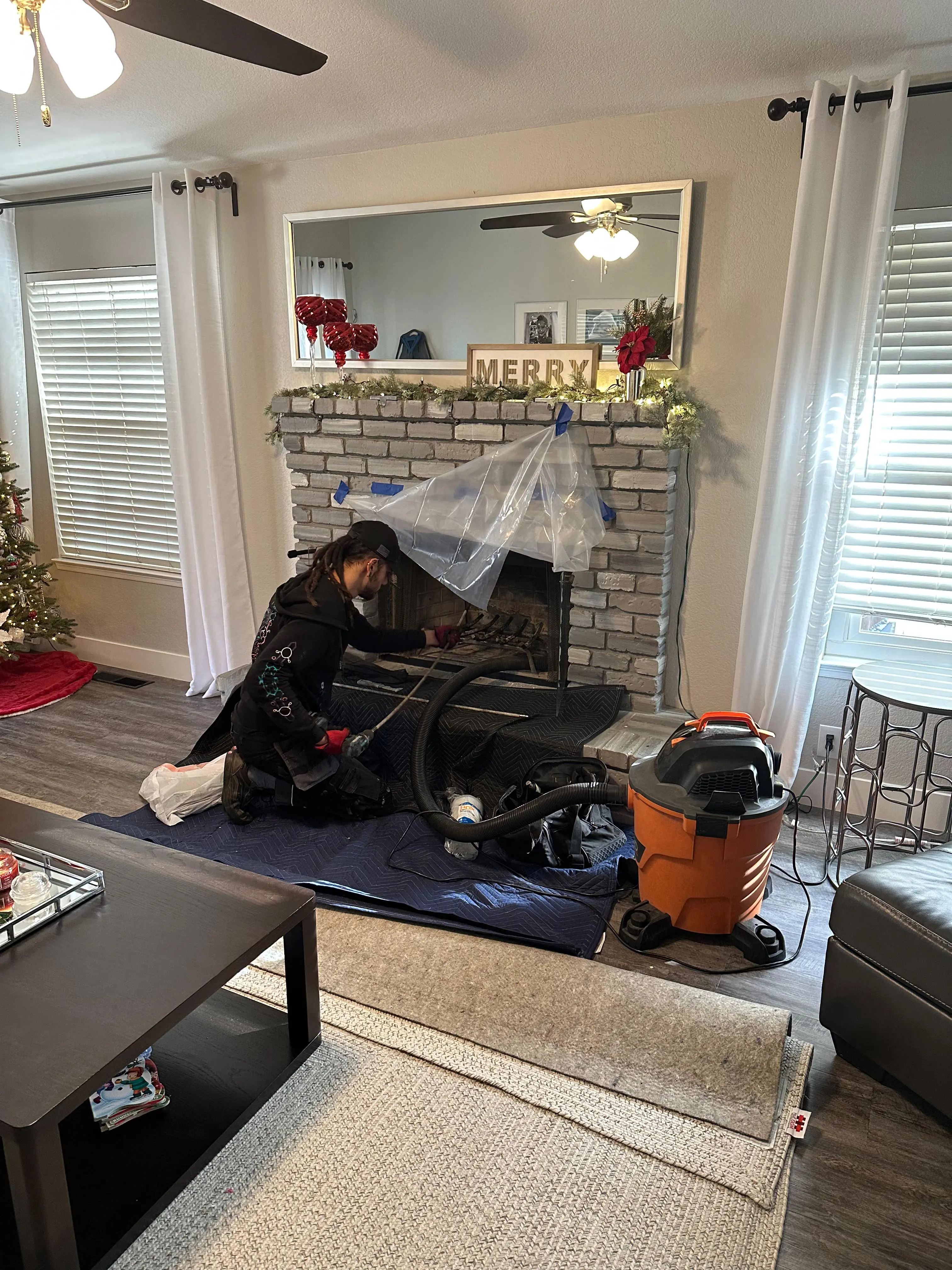 CSIA-certified technician sweeping a chimney at a Roseville home